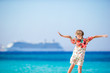 Adorable little girl at beach background big cruise lainer in Greece