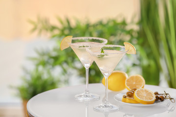 Canvas Print - Glasses with tasty lemon drop martini cocktail on table