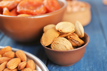 Wall Mural - Apricot stones in different dishes on wooden table