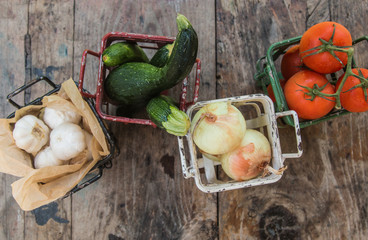 Wall Mural - Vegetables in metal baskets on distressed vintage wood background 