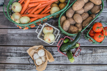 Wall Mural - Vegetables in metal baskets on distressed vintage wood background 