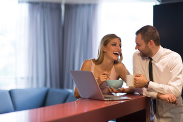 Wall Mural - A young couple is preparing for a job and using a laptop