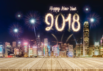 Wall Mural - Happy new year 2018 fireworks over cityscape at night with empty wood plank table top,Mock up template for display or montage of product for holiday promotion advertising.