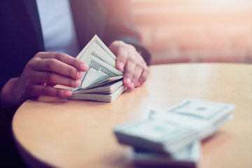 Businessman counting U.S. dollar bills.