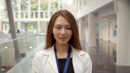 Wall Mural - Portrait Of Smiling Female Doctor In Lobby Of Hospital