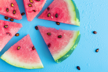 Wall Mural - Watermelon slice popsicles on a blue background