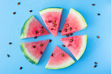 Wall Mural - Watermelon slice popsicles on a blue background