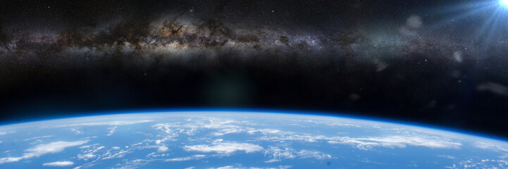 Wall Mural - the milky way appears over the horizon of planet earth