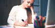 © shefkate - Young woman working in office, sitting at desk