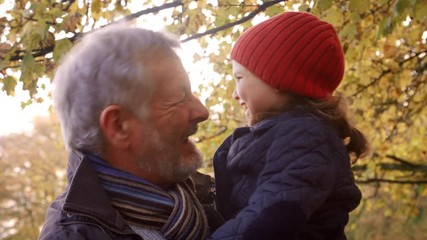 Wall Mural - Grandfather Walking With Granddaughter In Autumn Countryside