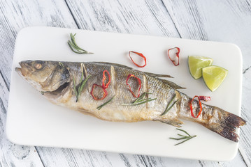 Wall Mural - Baked sea bass with lime and chilli pepper