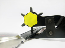 Tool Used To Pierce Belts, Watch And Shoes With White Background.