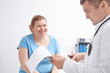 © Africa Studio - Overweight woman discussing test results with doctor in hospital