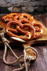 Wall Mural - Pretzels on wooden board on rustic background. german food.