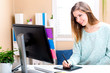 © Tierney - Graphic designer using her graphic tablet in an office