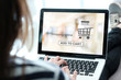 © mangpor2004 - Woman hand typing laptop with shopping online device on screen background, digital marketing, business and technology concept, lifestyle