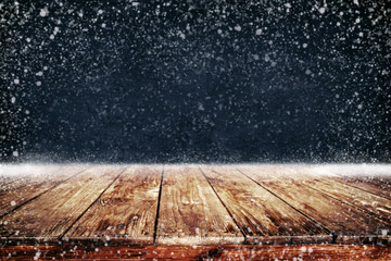 Wall Mural - christmas and new year background with wooden deck table and snowfall. empty display for product mon