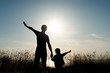 © ruslanshug - happy father and son on sea sunset background