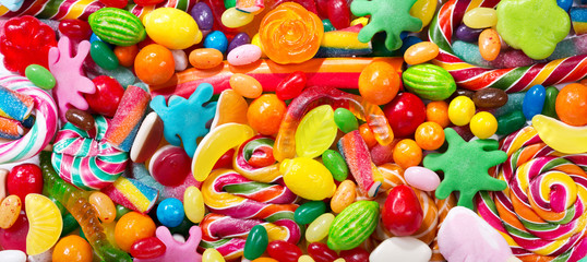 various colorful candies, jellies, lollipops and marmalade