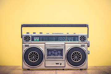 Wall Mural - retro outdated portable stereo boombox radio cassette recorder from 80s front yellow background. vin