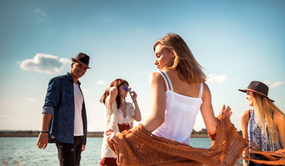 Wall Mural - Group of friends dancing and celebrating on beach, party outdoor