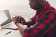 © Prostock-studio - Black businessman in casual office, work with laptop