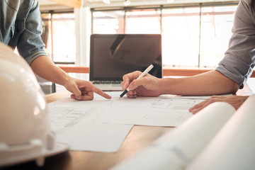 Image of engineer or architectural project, two engineering discussing and working on blueprint with architect equipment, Construction concept