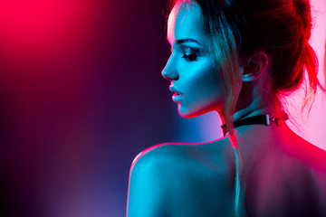 beautiful sexy girl with trendy make-up in colorful bright lights