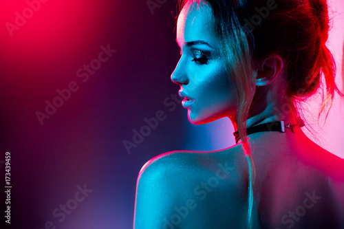 Beautiful sexy girl with trendy make-up in colorful bright lights Wallpaper Mural