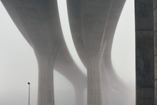Pillars Of The Highway Bridge In Fog