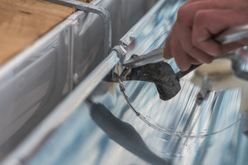 Close-up of a newly installed gutter on a roof. Craftsmanship in tranditional construction.