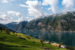 © Anna Kutukova - Top view of Norway fjord coast with small village. Green field and tiny wooden houses on the bank of Aurlandsfjord. Ilyllic peaceful landscape at summer