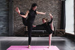 © undrey - Cute little child girl and adult woman doing standing split balance gymnastic exercise in a living room