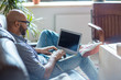 © pressmaster - Young analyst with laptop searching online data and statistics for report