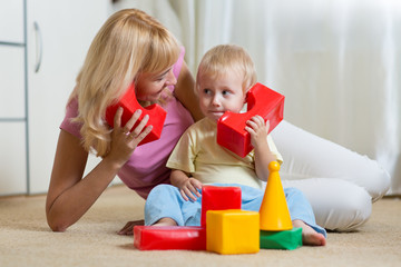 Wall Mural - cute mother and child boy role playing together at home