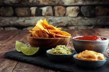 Nachos Tortilla Chips And JalapeÒos Chili Peppers Or Mexican Chili Peppers With Tomato, Cheese And Guacamole Dip