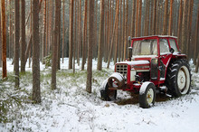 Red Tractor. Red Old Tractor In The North Pine Forest In Winter.