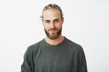 portrait of beautiful mature blonde bearded guy with trendy hairdo in casual grey shirt smiling and 