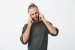 © Cookie Studio - Beautiful nordic man with trendy haircut and beard being tired, massaging temples with fingers trying to concentrate on work.