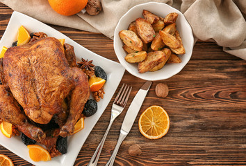 Canvas Print - Tasty roasted turkey with slices of orange and prune on plate