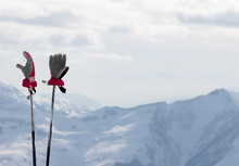 Gloves On Ski Poles And Snow Winter Mountains