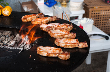 delicious beef steaks on the grill with flames