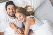 © Yakobchuk Olena - Joyful loving couple luxuriating in bedroom together