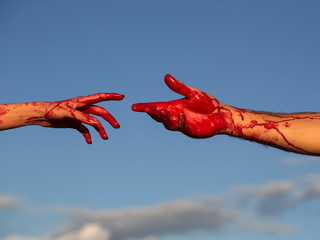 Fototapeta bloody zombie hands with red blood on blue sky