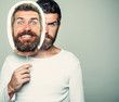 © Volodymyr - Hipster with sad and happy face hold portrait nameplate.