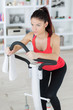 © auremar - fit woman exercising on step machine in living room