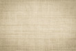 Old jute hessian sackcloth canvas sack cloth woven texture pattern background in aged yellow beige cream brown color