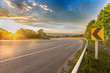 © APIWICH - curve on the road sunset with sign symbol