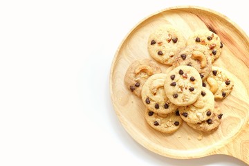  cookies on wooden plate with white background