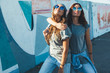 © Alena Ozerova - Models wearing plain tshirt and sunglasses posing over street wall